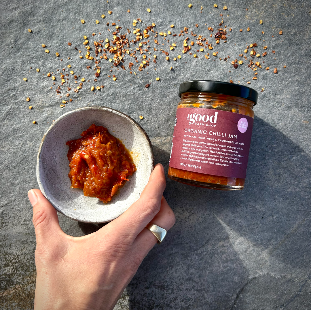 The Good Farm Shop Chilli Jam served in a glass jar with chilli flakes 