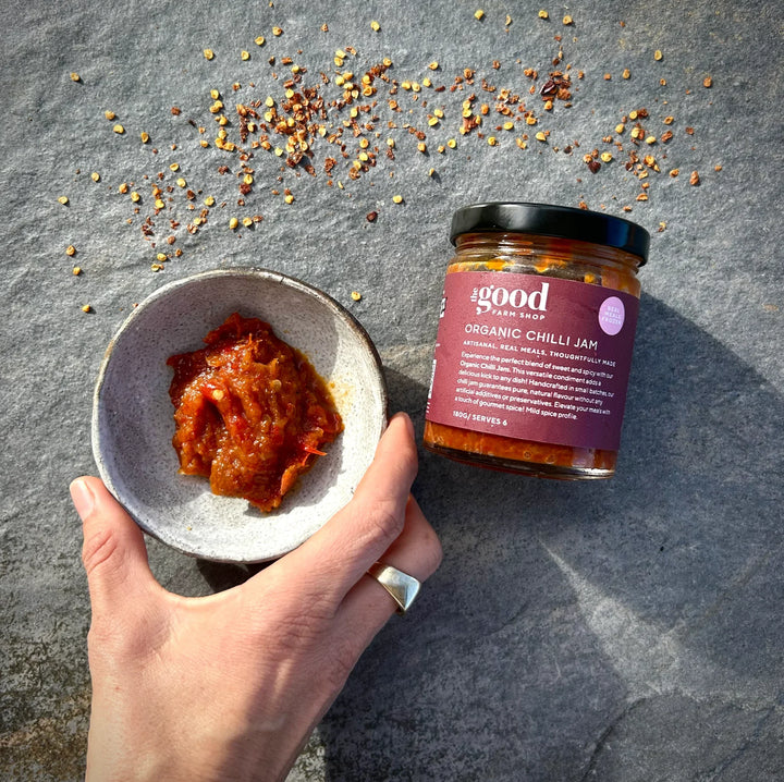 The Good Farm Shop Chilli Jam served in a glass jar with chilli flakes 