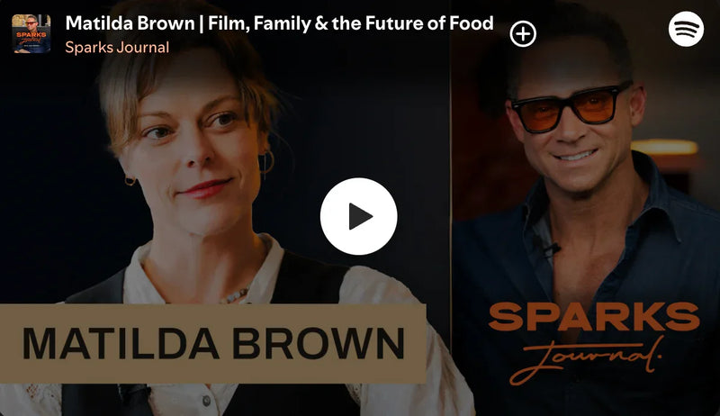 Promotional graphic for Matilda Brown featuring a play button and 'Sparks Journal' branding.